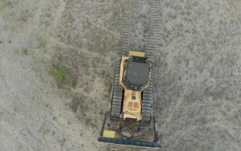 Stock Video Bulldozer Driving Through A Dirt Field For PC