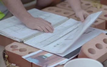 Stock Video Builders Reviewing A Construction Plan Closeup For PC