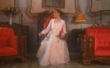 Stock Video Brunette Woman Sitting In A Vintage Chair For PC