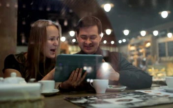 Stock Video Browsing Photos In A Cafe For PC