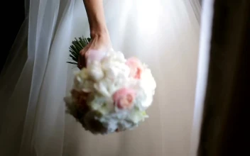 Stock Video Bride In Wedding Dress Smells Bouquet Of Roses For PC