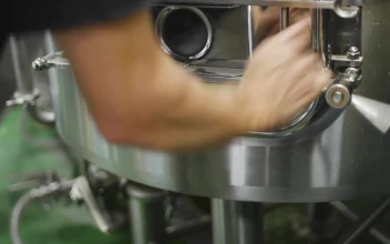 Stock Video Brewer Opening A Barley Bagasse Tank For PC