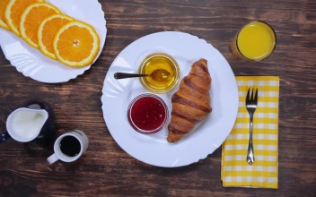 Stock Video Breakfast At A Table With Bread Coffee And Fruit For PC