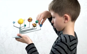 Stock Video Boy With A Model Of The Solar System For PC