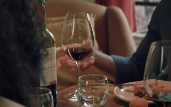 Stock Video Boy Takes His Glass Of Wine During A Dinner With For PC