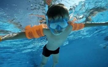 Stock Video Boy Swimming In The Pool And Saying Hi For PC