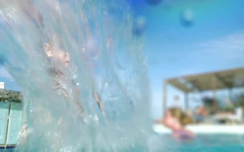 Stock Video Boy Splashing The Camera With Pool Water For PC