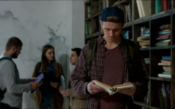 Stock Video Boy Reading A Book In A Library For PC