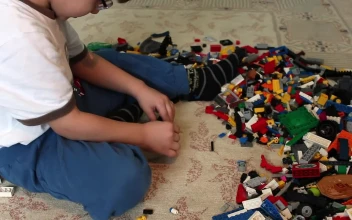 Stock Video Boy Playing With Many Lego Pieces On The Floor For PC