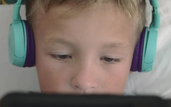 Stock Video Boy Playing Games On A Small Tablet For PC