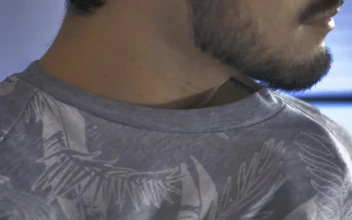 Stock Video Boy Placing A Lapel Microphone On His Shirt For PC