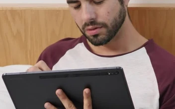 Stock Video Boy Lying Concentrated With A Tablet Before Sleeping For PC