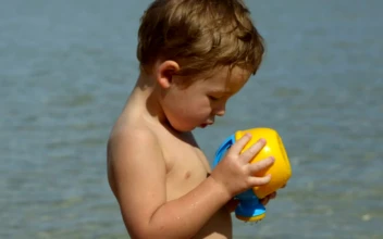 Stock Video Boy Looking At A Beach Toy For PC