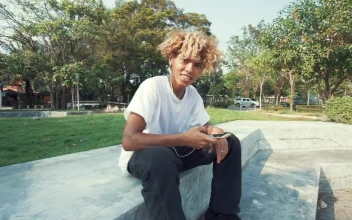 Stock Video Boy Listening To Music With Headphones In A Park For PC