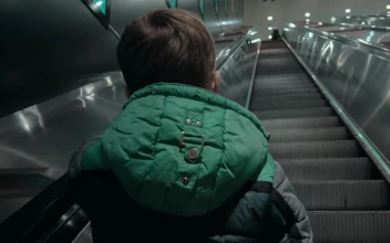 Stock Video Boy Heading Up An Escalator For PC