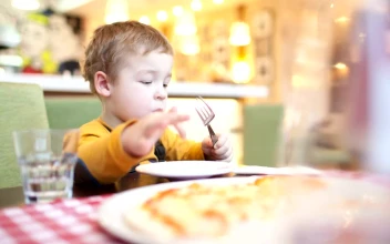 Stock Video Boy Eating Breakfast In A Cafe For PC