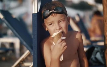 Stock Video Boy Eating An Ice Cream While Looking Away For PC