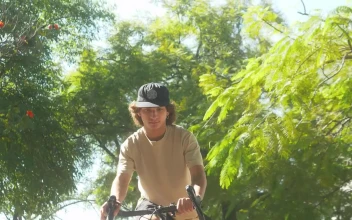 Stock Video Boy Doing A Wheelie On A Bike In A Park For PC