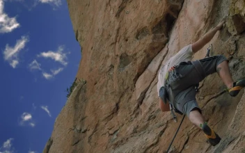 Stock Video Boy Climbing Up A Rocky Mountain For PC