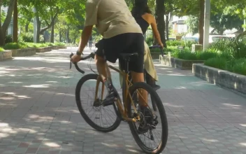 Stock Video Boy And Girl Zigzagging During A Bike Ride For PC