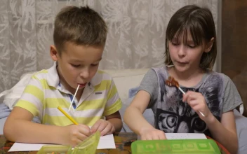 Stock Video Boy And Girl Eating Candy While Drawing For PC