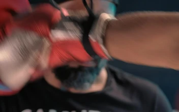 Stock Video Boxing Coach Getting Punches On A Pad For PC