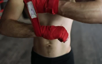 Stock Video Boxer Wraps Hands To Prepare For Training For PC