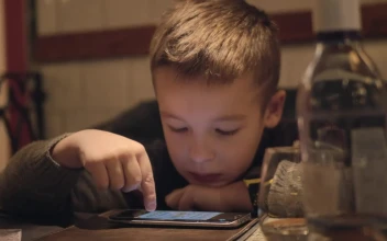 Stock Video Bored Boy Using A Phone In A Cafe For PC