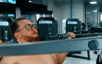 Stock Video Bodybuilder Doing Shoulder Exercises At The Gym For PC
