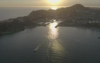 Stock Video Boats And Motorboats Sailing Along A Coastline During Sunset For PC
