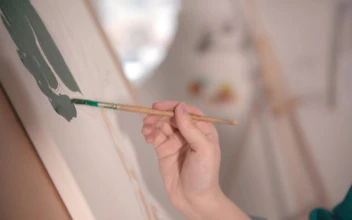 Stock Video Blonde Artist Painting On Canvas For PC