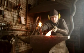 Stock Video Blacksmith Making A Knife With A Hammer On The Forge For PC