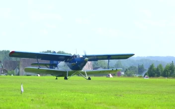 Stock Video Biplane Crossing The Grass Field For PC