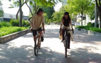 Stock Video Bike Ride Of A Couple Through A City Park For PC