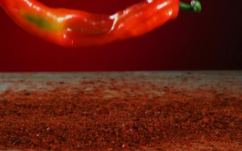 Stock Video Big Red Pepper Falling Into Red Powder For PC