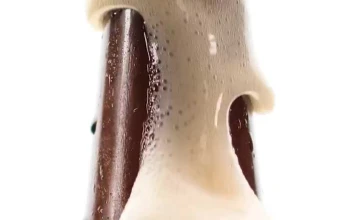 Stock Video Beer Bottle Spilling Foam On A White Background For PC