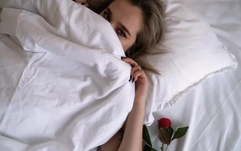 Stock Video Beautiful Woman In Bed Covers Face And Winks For PC
