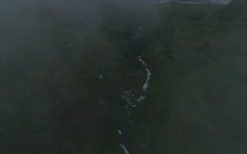 Stock Video Beach Under Mountains In A Foggy Landscape For PC