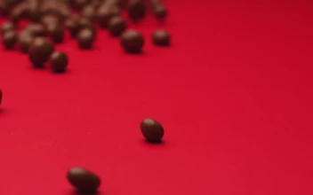 Video Stock Chocolate Beans Rolling On A Red Surface For PC