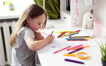 Video Stock Child Sitting At Her Desk Drawing For PC