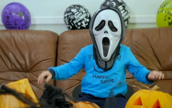 Video Stock Child In Scream Halloween Mask Makes Spooky Hand Gestures For PC