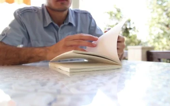 Video Stock Chico Leafing Through A Book To Start Reading For PC
