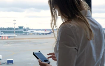 Video Stock Checking Her Phone While Waiting For A Flight For PC