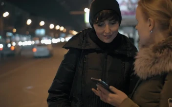 Video Stock Checking Her Phone While Waiting For A Bus For PC
