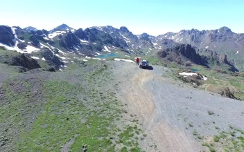 Video Stock Car And Man On A Mountain Peak Looking To The For PC