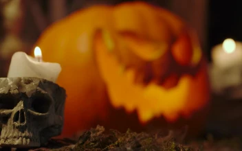 Video Stock Candles On The Sides Of A Lighted Halloween Pumpkin For PC