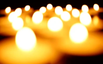 Video Stock Candles Lighting Up In The Dark Out Of Focus For PC