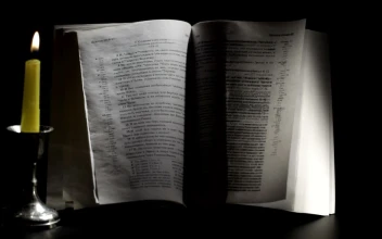 Video Stock Candle Burning Next To A Bible For PC