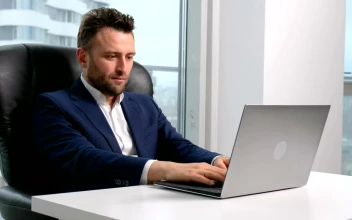 Video Stock Businessman Working On A Laptop At His Desktop For PC