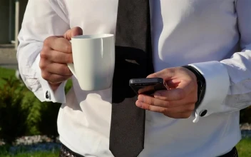 Video Stock Businessman With Coffee Mug Checking Mobile Phone For PC